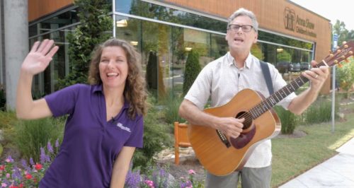 man with guitar and woman singing