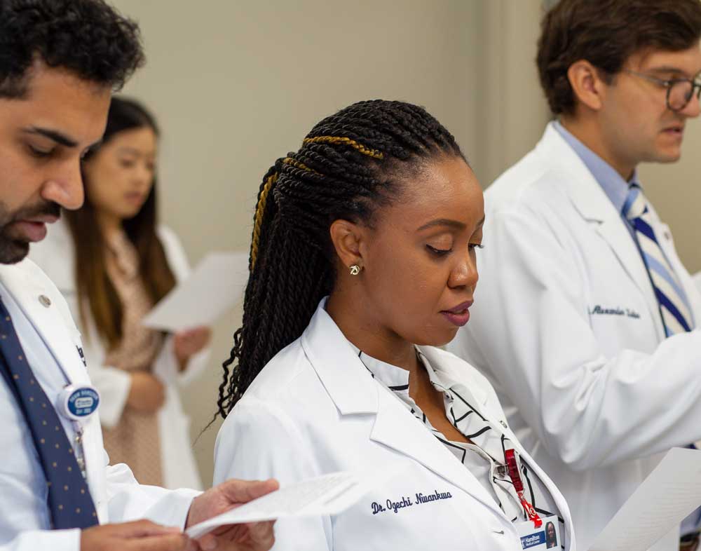 Dr. Ogechi Nwankwo reads oath in white coat ceremony at hamilton medical center in dalton, ga for residency program