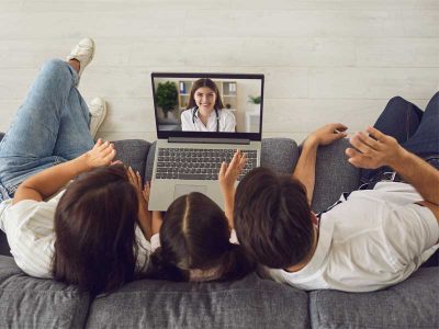 hamilton community telehealth - family doing a virtual doctor visit on their computer
