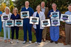 Hamilton leaders posing with CareChex award plaques.