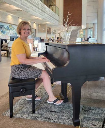 Charlise Defore playing the piano at Peeples Cancer institute in dalton, ga