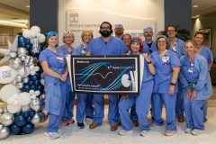 Hamilton Medical Center (HMC) is now providing a new renal denervation (RDN) procedure for certain patients with high blood pressure, also known as hypertension. Cardiac surgery associates are picture with Sonny Achtchi, DO (holding banner), who performed the first procedure at HMC.