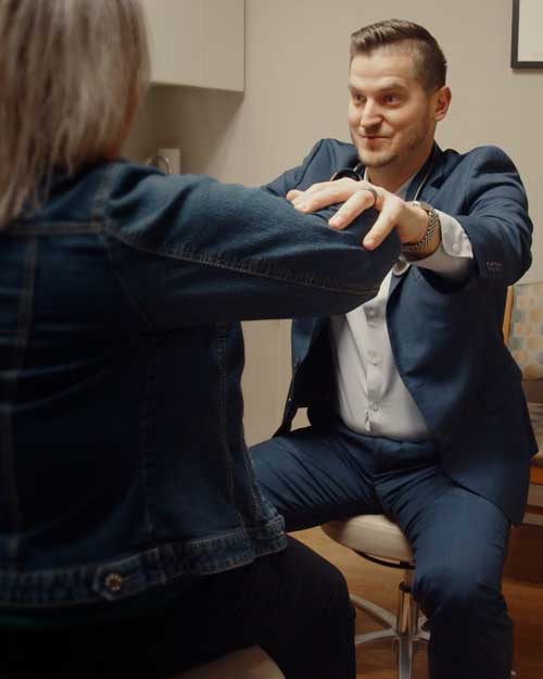 Dr. Hare exams a patient with chronic back pain
