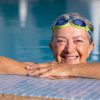 senior woman on pool's edge smiling